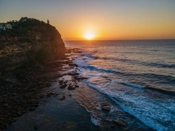 istock Aerial sunrise seascape with hazy blue sky 1300600250