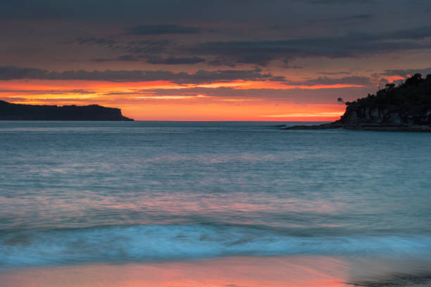 Sunrise seascape with high cloud filled sky from Pearl Beach on the Central Coast, NSW, Australia.