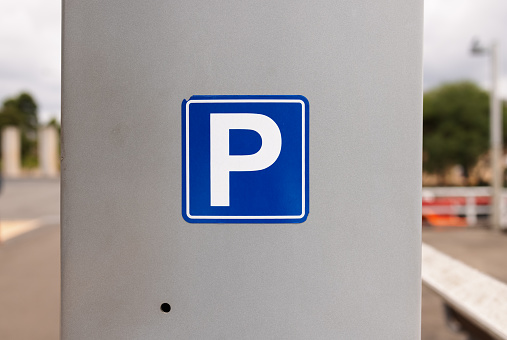 Blue sign indicating a parking ticket machine .