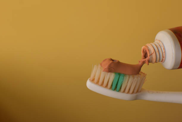 istock Toothbrush with red ayurvedic toothpaste. Close up of red toothpaste squeezed on toothbrush. 1300602106