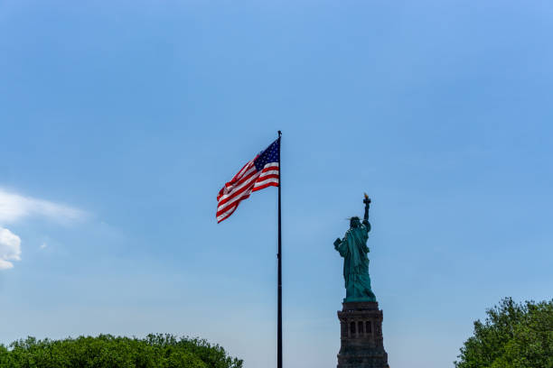 istock American Flag and Statue of Liberty 1300602911