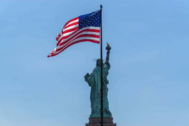 istock American Flag and Statue of Liberty 1300602925