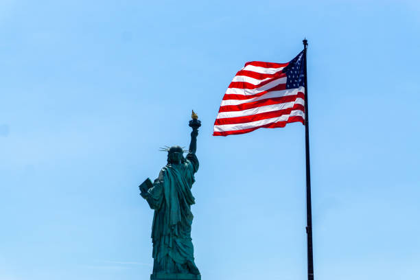 istock American Flag and Statue of Liberty 1300602933