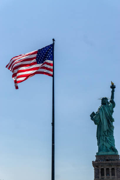 istock American Flag and Statue of Liberty 1300602975