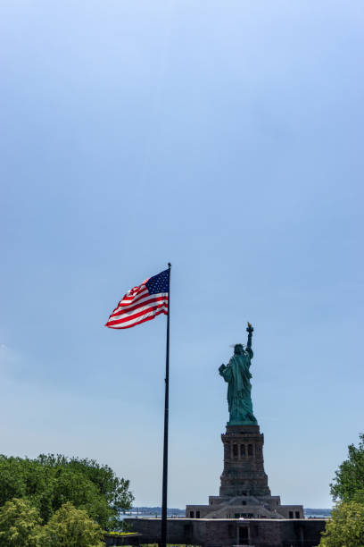 istock American Flag and Statue of Liberty 1300603029
