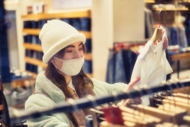 istock Women in a protective mask doiing shoppig 1300603678