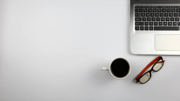 istock laptop, glasses and a cup of coffee 1300603755