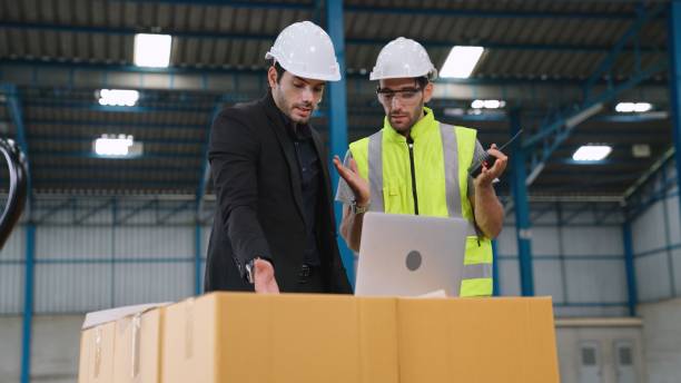 istock Two factory workers working and discussing manufacturing plan in the factory . 1300607021