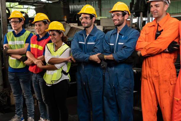 istock Skillful worker stand together showing teamwork in the factory . 1300607427