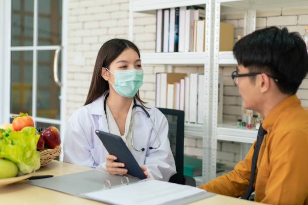istock Nutritionist talking to male patient 1300608130