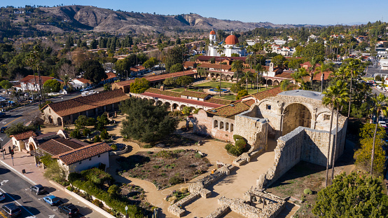 Daytime aerial view of the Spanish Colonial era mission and surrounding city of downtown San Juan Capistrano, California, USA.