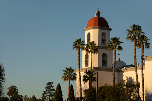Late afternoon sun shines on the historic Basilica and historic district of San Juan Capistrano, California, USA.