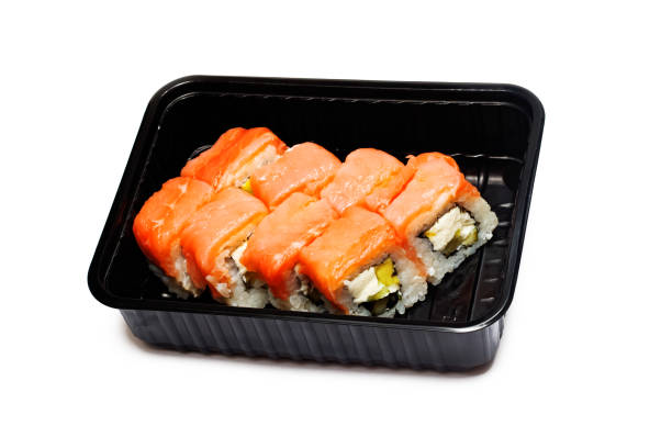 istock Salmon rolls in black box, isolated on white background 1300616196
