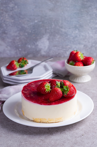 Homemade white chocolate cheesecake with strawberry jelly and strawberries