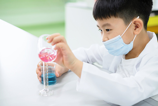 Pink Experiment Elementary School Student Doing A Science Experiment A Boy Pouring Pink ...