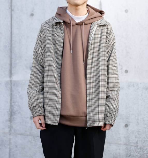 istock Young man standing in front of a concrete wall 1300618441