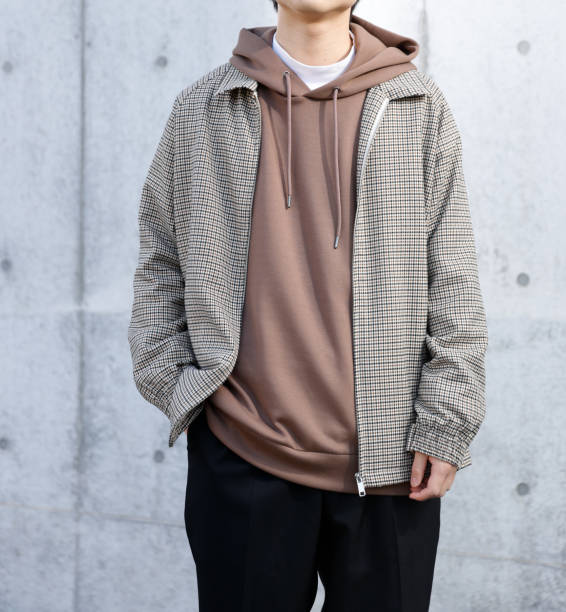 istock Young man standing in front of a concrete wall 1300618487