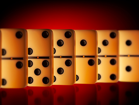 Domino placed in a row on red background.