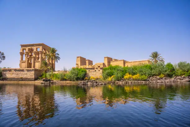 The beautiful temple of Philae and the Greco-Roman buildings seen from the Nile river, a temple dedicated to Isis, goddess of love. Aswan. Egyptian