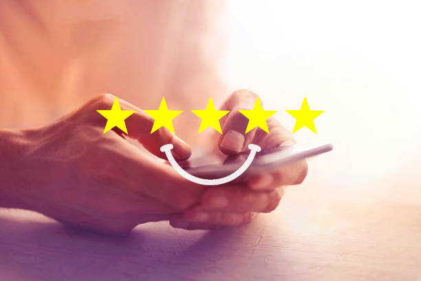 istock Customer Hands on Phone with Yellow Five Stars and Smile Rate Satisfaction Feedback 1300622694