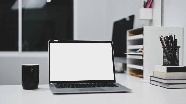 istock Laptop computer, coffee cup and office supplies on office desk. 1300627175
