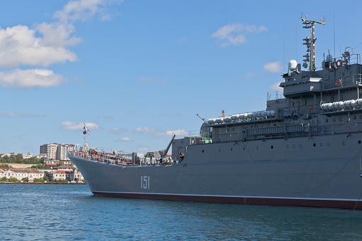 Navy frigate moored at naval dockyard.