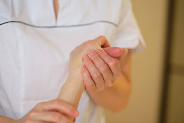 istock Wrist massage. massage therapist puts pressure on a sensitive point on a woman's hand. Physiotherapist massaging her patients hand in medical office 1300630700