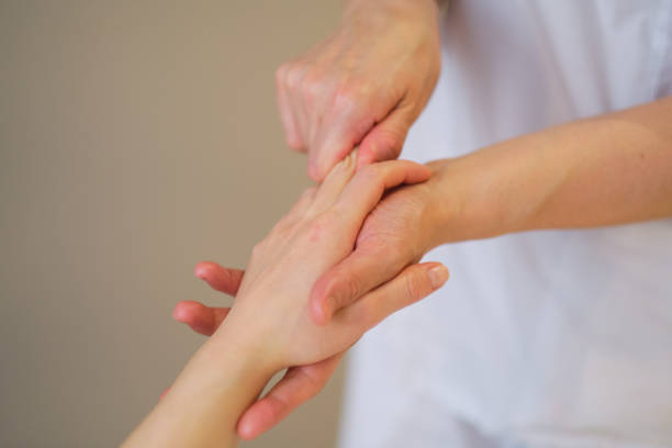 istock Wrist massage. massage therapist puts pressure on a sensitive point on a woman's hand. Physiotherapist massaging her patients hand in medical office 1300630709