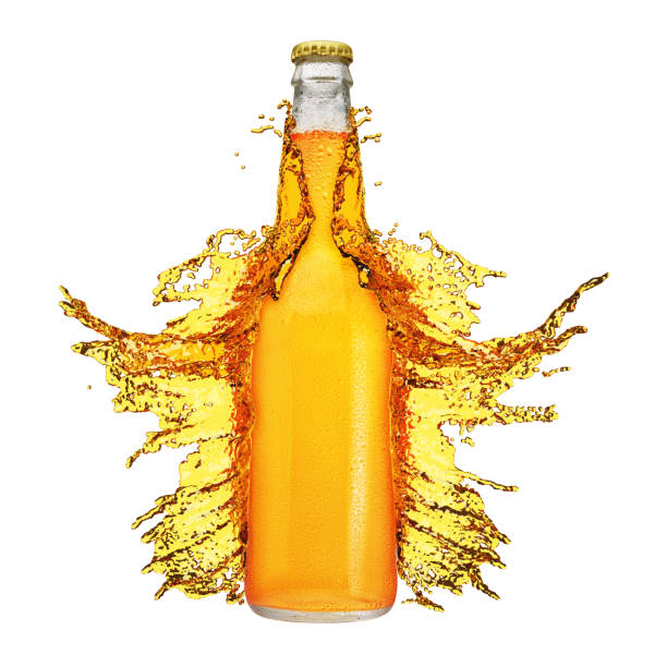 istock Beer bottle with droplets and splash isolated on white. 1300634311