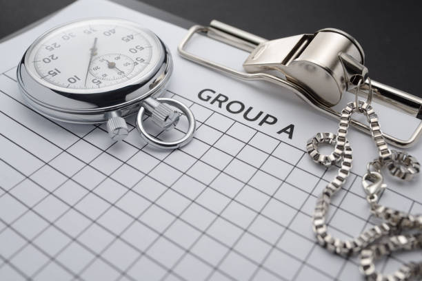 Clipboard with blank paper form, mechanical stopwatch and metal whistle.