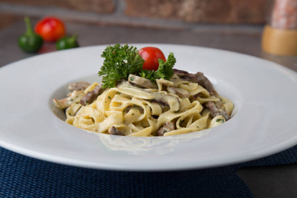istock Pasta with beef, greens and tomatoes 1300635374