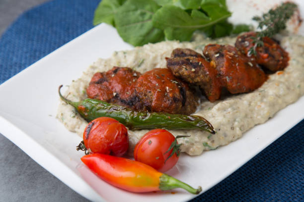 istock Meatballs on eggplant puree with pepper and tomato 1300635526