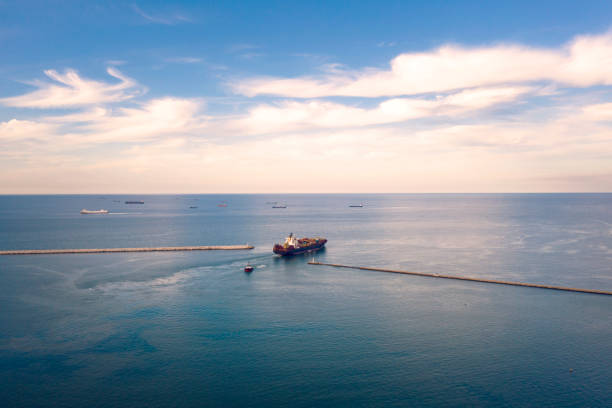 istock Aerial view of Cargo ship leaving port 1300636286