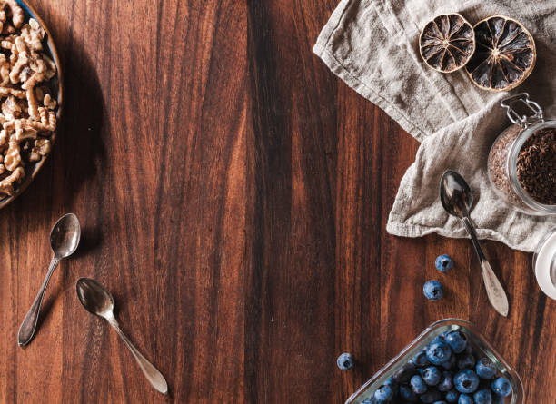 Blueberries, seeds and nuts on a wooden table directly from above