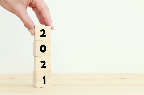 istock 2021 concept. cubes on wooden table 1300641727