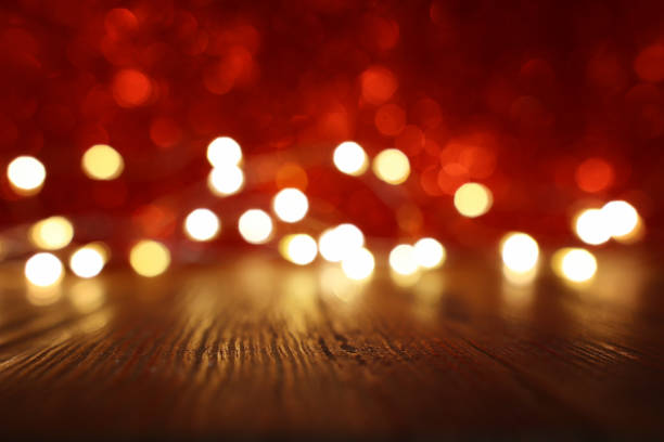 istock Empty rustic table in front of Valentine's day or christmas glitter bokeh background with gold lights. Ready for product display montage 1300641730