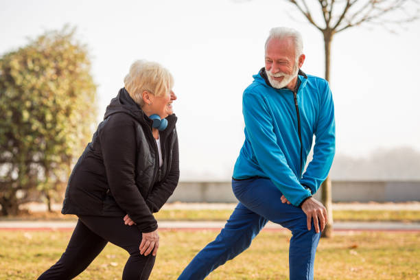 istock Two seniors are doing exercises on sunny day in public park. 1300642960