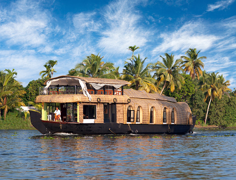 Alleppey, India - November 7, 2016: Tourists on houseboat floating in backwaters in Kerala state, South India