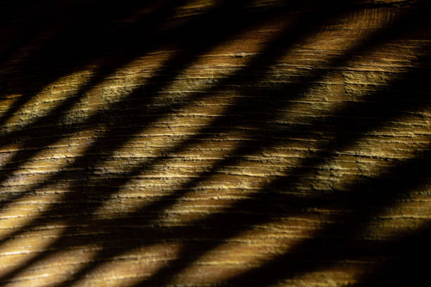 Lighting on demolition wood. Dark mode wallpaper concept.