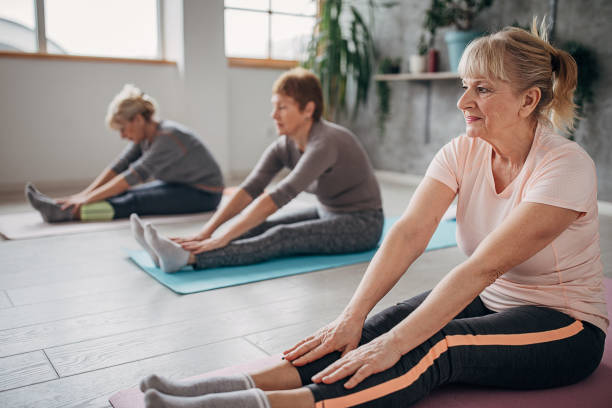 istock Senior women exercising yoga 1300651765