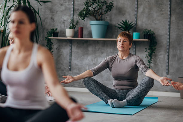 istock Women on yoga class exercising together 1300651829