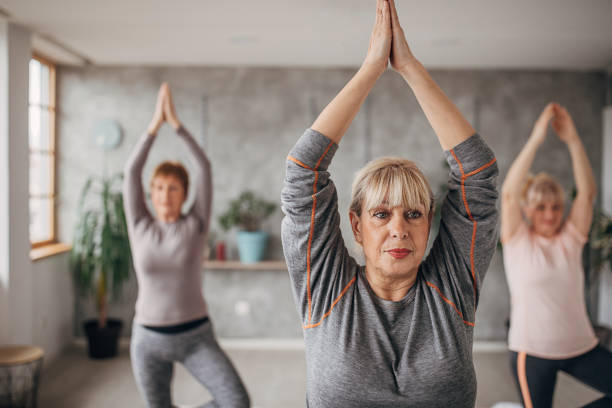 istock Senior women exercising yoga 1300652671