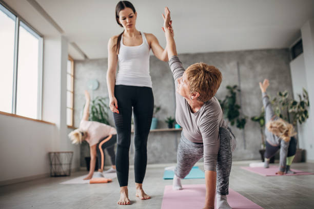 istock Yoga instructor with senior women on yoga class 1300652847