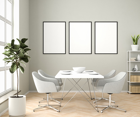 Interior setting with dining area and three blank picture frame mockups.