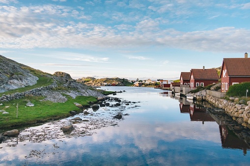 Bodo - Norway. June 17, 2023: A vibrant summer view from the Bodo to Lofoten Islands ferry in Norway showcases Bodo's bustling commercial and tourist port, framed by a clear blue sky offers particularly spectacular coastal scenery