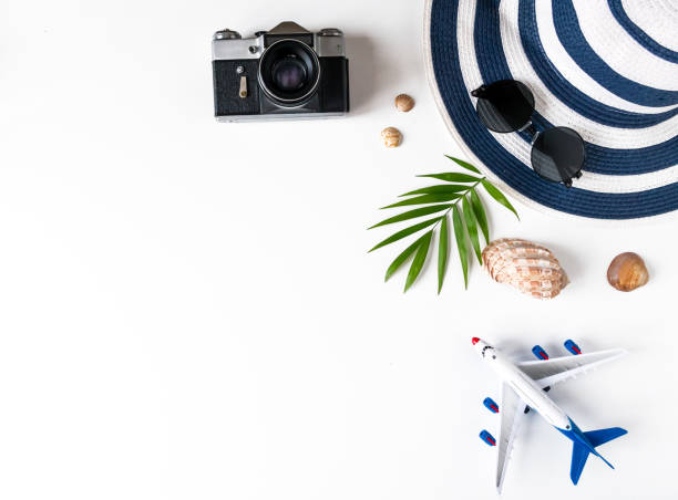 istock Things for summer holidays: a camera, shells, an airplane, sunglasses, a hat, a palm tree 1300653883