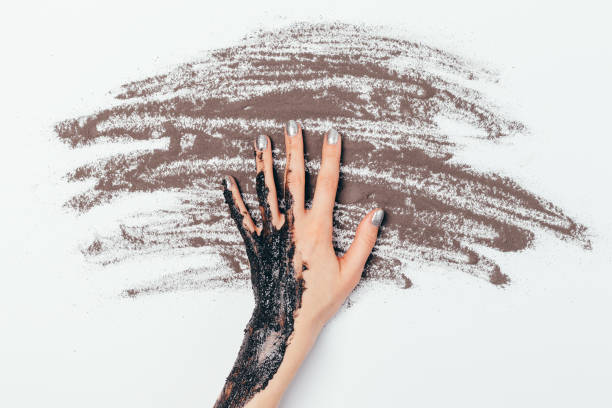 istock Top view female hand with applied cosmetic scrub mask 1300654030