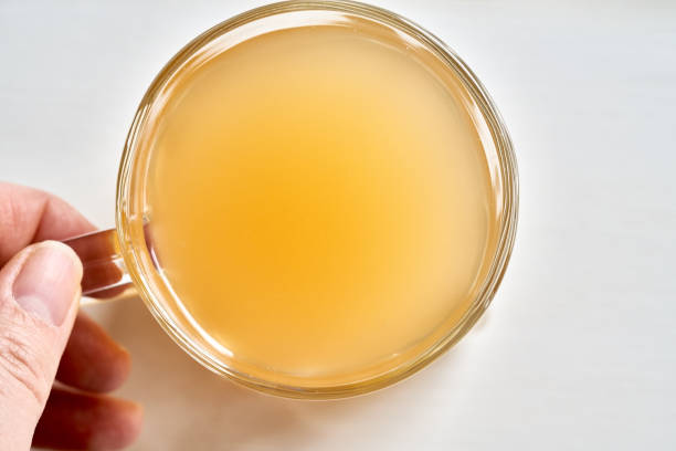 istock A cup of beef bone broth held by a hand on a white background 1300655475