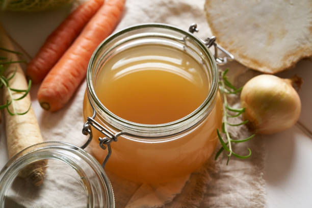 istock Homemade beef bone broth in a glass jar, with carrots, celery root and other vegetables 1300655526