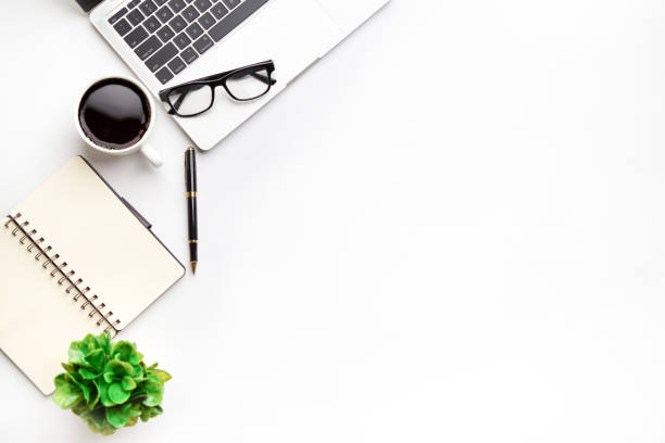 istock Flat lay, top view office table desk. Workspace with, laptop,office supplies, pencil, green leaf, and coffee cup on white background. 1300657916